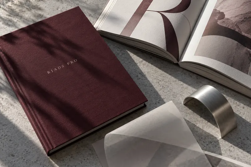 RIADS PRO editorial study with clothbound books, paper and sculpted metal